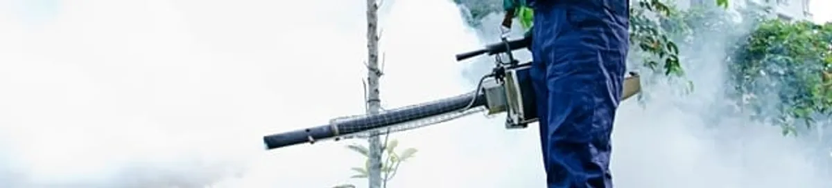 Pest control technician fogging an outdoor area for insect control in Fort Wayne, IN